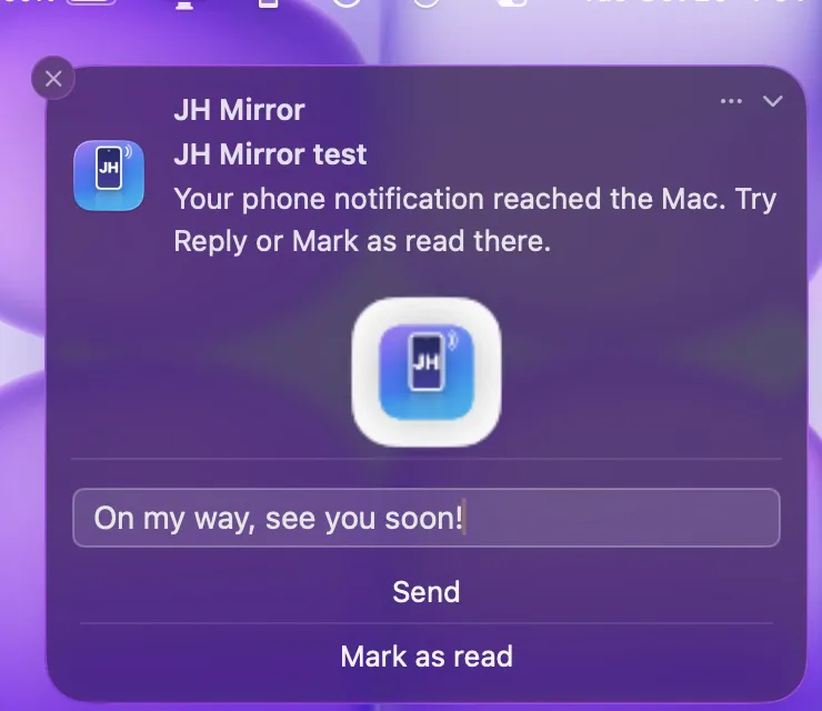 A phone notification on the Mac with the reply 'On my way, see you soon!' typed in